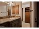 Bathroom features a sink with granite countertop, cabinet storage and a walk-in closet at 12711 N 117Th St, Scottsdale, AZ 85259