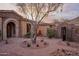 Inviting courtyard with decorative fountain, mature tree, and stone-accented architecture at 12711 N 117Th St, Scottsdale, AZ 85259