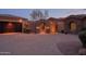 Elegant home featuring a stone archway leading to the entrance and an expansive paver driveway at 12711 N 117Th St, Scottsdale, AZ 85259