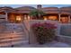Beautiful home exterior with stone staircase, lush flowering bushes, and architectural details at 12711 N 117Th St, Scottsdale, AZ 85259