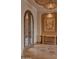 Elegant foyer with decorative tile flooring, ornate light fixture, and custom ironwork door at 12711 N 117Th St, Scottsdale, AZ 85259