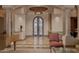 Grand foyer featuring custom tile flooring, arched doorway, and decorative columns at 12711 N 117Th St, Scottsdale, AZ 85259