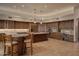 Gourmet kitchen with granite counters, custom cabinetry, built-in appliances, and a breakfast bar at 12711 N 117Th St, Scottsdale, AZ 85259