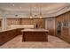 Luxury kitchen featuring custom wood cabinetry, granite countertops, a center island, and modern appliances at 12711 N 117Th St, Scottsdale, AZ 85259