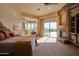 Spacious main bedroom with a fireplace, sitting area, and access to outdoor pool at 12711 N 117Th St, Scottsdale, AZ 85259
