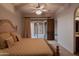 An elegant primary bedroom with carpet, a ceiling fan and sliding glass door for outdoor access at 12711 N 117Th St, Scottsdale, AZ 85259