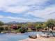 A backyard pool features a stone patio, fire pit, lush landscaping, and mountain views at 12711 N 117Th St, Scottsdale, AZ 85259