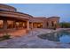This home features a pool with a spa, rock features, and a covered patio at 12711 N 117Th St, Scottsdale, AZ 85259