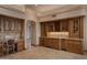 Luxurious wet bar area with custom cabinetry, a wine rack, a sink, and built-in appliances at 12711 N 117Th St, Scottsdale, AZ 85259