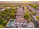 Home from above with view of surrounding neighborhood in distance at 14095 W Larkspur Dr, Surprise, AZ 85379