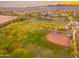 An aerial view of a baseball field and community with many trees at 14095 W Larkspur Dr, Surprise, AZ 85379