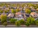 Aerial view featuring backyard pool and neighborhood with mature trees and well-maintained homes at 14095 W Larkspur Dr, Surprise, AZ 85379