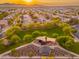 An aerial view of a community park with playground, picnic areas, and lush landscaping at 14095 W Larkspur Dr, Surprise, AZ 85379
