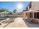 Backyard showcases a sparkling pool, patio with picnic table, and chaise lounges for ultimate relaxation at 14095 W Larkspur Dr, Surprise, AZ 85379