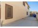 A spacious backyard features a concrete patio and beige stucco wall at 14095 W Larkspur Dr, Surprise, AZ 85379