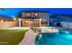Relaxing backyard with a pool, sun loungers, patio, and ambient string lights at 14095 W Larkspur Dr, Surprise, AZ 85379