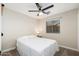Cozy bedroom featuring carpet, a queen bed, a window, and a ceiling fan at 14095 W Larkspur Dr, Surprise, AZ 85379