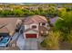 Well maintained two-story home with red accents, two car garage, and mature landscaping at 14095 W Larkspur Dr, Surprise, AZ 85379