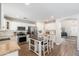 Bright kitchen with kitchen island, stainless appliances, and white cabinets that opens to the living room at 14095 W Larkspur Dr, Surprise, AZ 85379