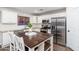 Bright, well-designed kitchen features an island, granite countertops, and stainless appliances at 14095 W Larkspur Dr, Surprise, AZ 85379