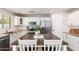 Bright kitchen features a kitchen island with seating, stainless appliances, and white cabinetry at 14095 W Larkspur Dr, Surprise, AZ 85379