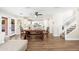 Open-concept area featuring wood floors, access to the backyard, and a modern white kitchen at 14095 W Larkspur Dr, Surprise, AZ 85379