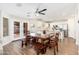 Open layout featuring wood floors, access to the backyard, and a bright white kitchen at 14095 W Larkspur Dr, Surprise, AZ 85379