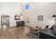 Open-concept area featuring high ceilings, wood floors, modern furnishings, and plenty of natural light at 14095 W Larkspur Dr, Surprise, AZ 85379