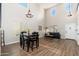 Bright living room with high ceilings, wood floors, and modern furnishings provides an open and airy atmosphere at 14095 W Larkspur Dr, Surprise, AZ 85379
