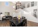 Spacious living room with high ceilings, wood-look floors, and an open staircase with iron railing at 14095 W Larkspur Dr, Surprise, AZ 85379