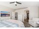 Main bedroom features a ceiling fan, carpeted floors, and large window at 14095 W Larkspur Dr, Surprise, AZ 85379