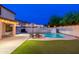 Beautiful backyard oasis with a pool, umbrellas, outdoor seating, and well-maintained landscaping at 14095 W Larkspur Dr, Surprise, AZ 85379