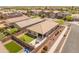 Aerial view of the property, highlighting landscaped backyard with patio, lush lawn, and convenient neighborhood access at 14166 W Valentine St, Surprise, AZ 85379