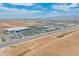 Expansive aerial view of the community featuring retail and commercial development under a bright, partly cloudy sky at 14166 W Valentine St, Surprise, AZ 85379