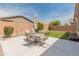 Backyard patio with outdoor seating area and green grass, perfect for entertaining at 14166 W Valentine St, Surprise, AZ 85379