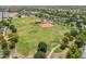 Aerial view of the lush green grass and baseball field with the surrounding community at 14166 W Valentine St, Surprise, AZ 85379