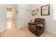 Cozy bedroom showcasing a recliner, decorative wall art, and convenient closet space with sliding doors at 14166 W Valentine St, Surprise, AZ 85379