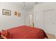 Bedroom featuring a red comforter and a closet with sliding doors, offering storage space at 14166 W Valentine St, Surprise, AZ 85379