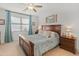 Bedroom featuring a wooden bed with blue comforter, offering a comfortable space at 14166 W Valentine St, Surprise, AZ 85379