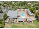 Aerial view of the community pool with ample seating, a large parking lot and well maintained landscaping at 14166 W Valentine St, Surprise, AZ 85379