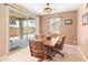 Comfortable dining area with a wooden table set and sliding glass door to the outdoor patio at 14166 W Valentine St, Surprise, AZ 85379