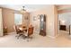 Dining room featuring tan walls, tile flooring, a wooden table and chairs, and natural light at 14166 W Valentine St, Surprise, AZ 85379