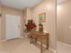 Inviting entryway featuring neutral walls, tile flooring, and an accent table with decorative items at 14166 W Valentine St, Surprise, AZ 85379