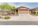 Charming single-story home with a two-car garage, desert landscaping, and inviting curb appeal at 14166 W Valentine St, Surprise, AZ 85379