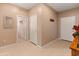 Bright hallway with tile flooring and white doors, complemented by a decorative mirror at 14166 W Valentine St, Surprise, AZ 85379