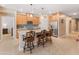 Charming kitchen featuring an island with bar seating, stainless steel appliances, and wood cabinetry at 14166 W Valentine St, Surprise, AZ 85379