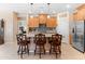 Modern kitchen features a large granite island with barstool seating and stainless steel appliances at 14166 W Valentine St, Surprise, AZ 85379