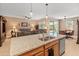Open-concept kitchen with granite counters, stainless appliances, flowing into a cozy living area at 14166 W Valentine St, Surprise, AZ 85379