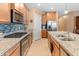 Spacious kitchen with stainless steel appliances, granite countertops, and a stylish backsplash at 14166 W Valentine St, Surprise, AZ 85379