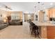 Open-concept living space featuring a cozy couch, ceiling fan, and seamless flow to dining area at 14166 W Valentine St, Surprise, AZ 85379